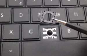 Naprawa klawisza laptopa pincetą.